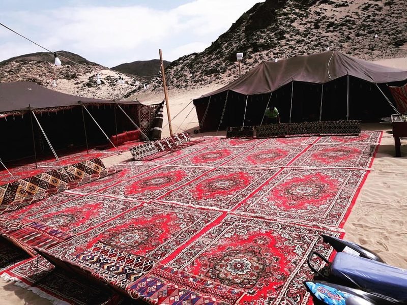 Carpets and tents in a mountainous desert camp